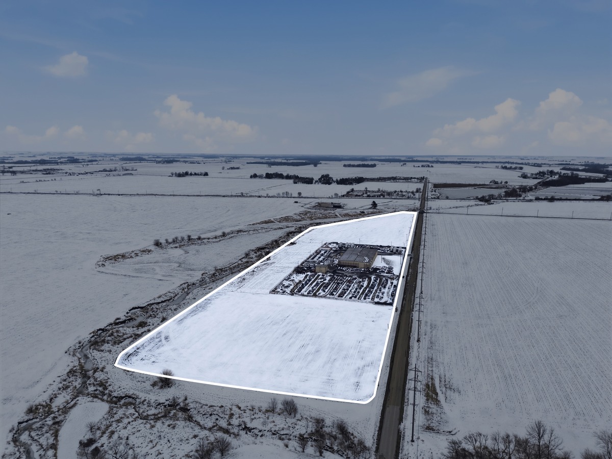 Our Mendota yard from the air in the snow, its property outlined in white: the shop and rows of donor vehicles beside the road