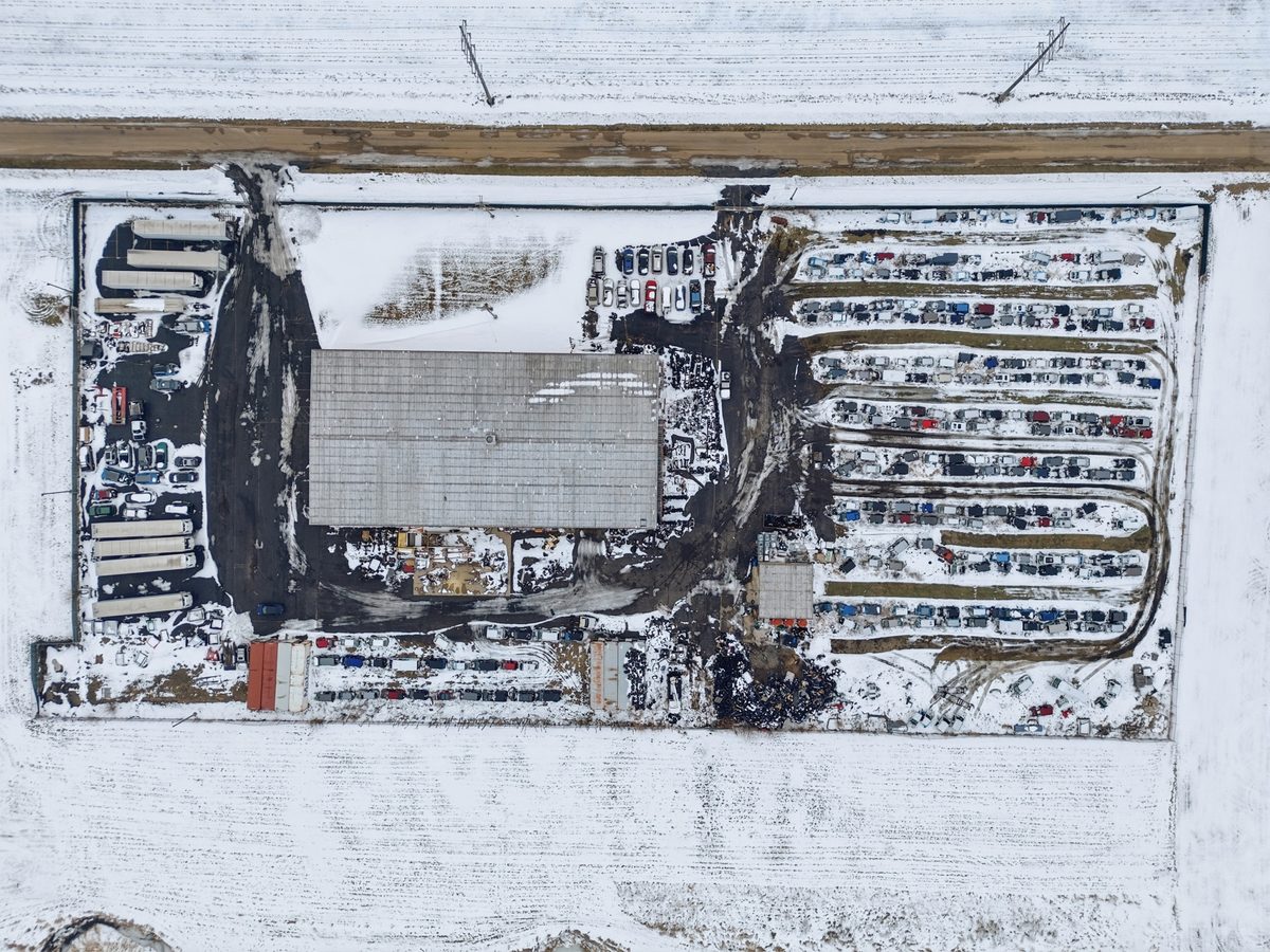 Our Mendota yard from above in the snow: the shop, rows of donor vehicles and trailers along the fence